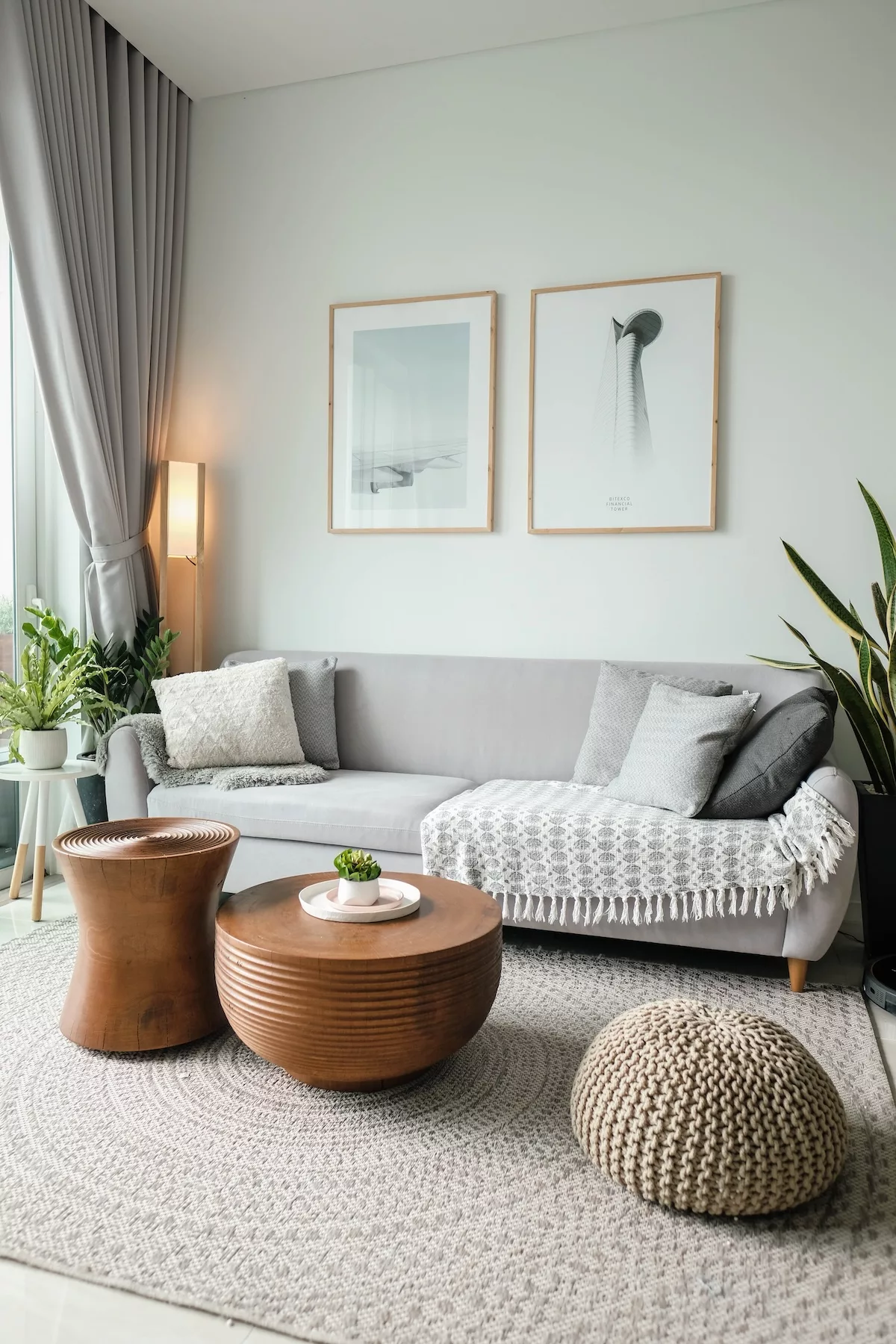 A cozy apartment living room with a gray couch, coffee table, and rug, creating a stylish and inviting space.