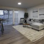 Living room with large windows and sliding door of 1 bed 1 bath floor plan