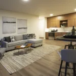 Open concept living room and kitchen of the 1 bed 1 bath floor plan, angle 2