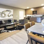 View of the kitchen and front door from the living room of the 2 bed 2 bath floor plan