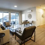 Living room with a view of the outdoors in the 3 bed 2 bath floor plan, angle one