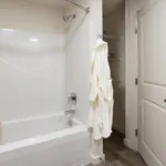 Bathtub and storage in the bathroom of the 3 bed 2 bath floor plan